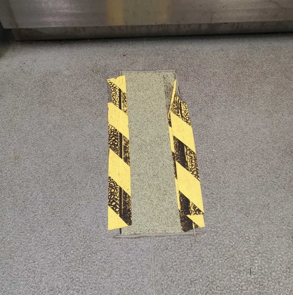 Lifted vinyl around drains — full replacement avoided.