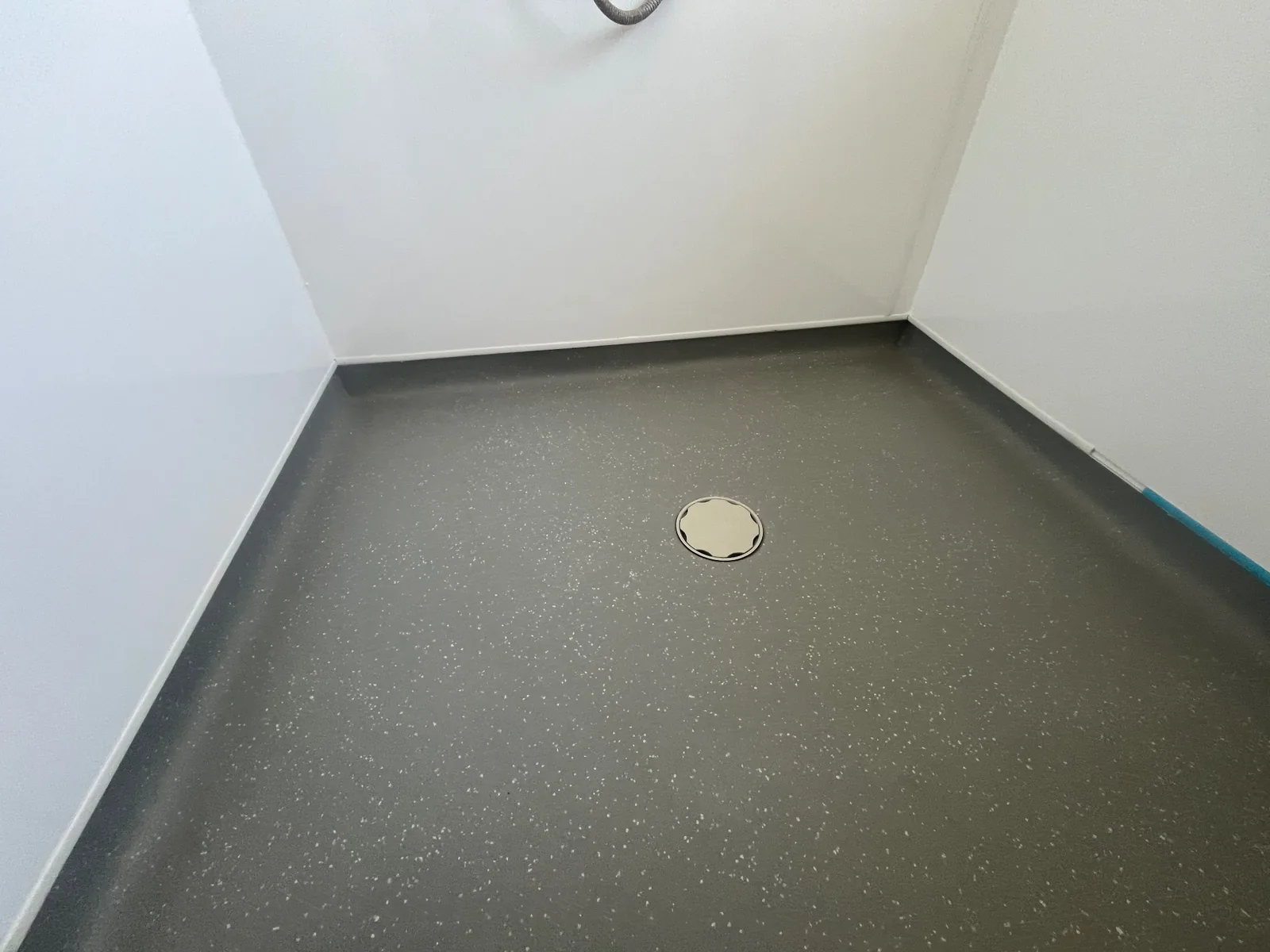 Dark grey wet room floor finish completed with full perimeter coving